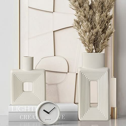 Geometric vases and small clock on a shelf