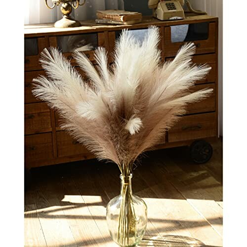 Pampas grass in a glass vase on wooden floor